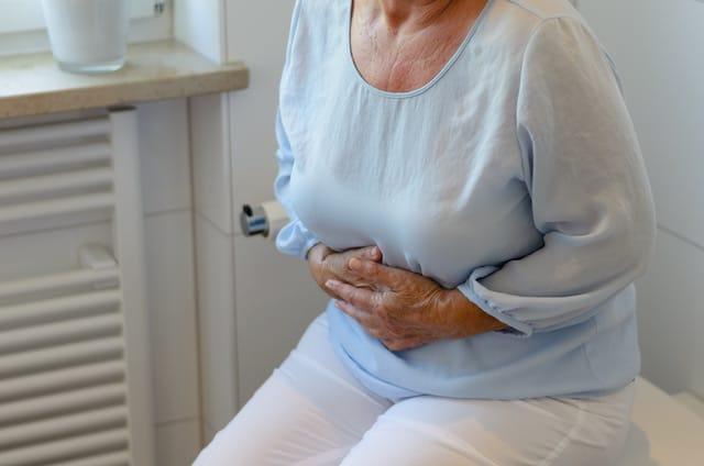 woman holding abdomen