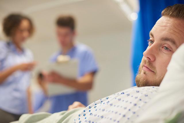 man in hospital bed